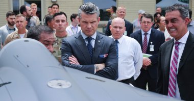 U.S. Secretary of Defense Pete Hegseth (L) is briefed on an exhibit of multi-domain autonomous systems by Alexander Lovett (L), the deputy assistant secretary of defense prototyping and experimentation, and Emil Michael (R), under secretary of defense for research and engineering, Arlington, Virginia, U.S., July 16, 2025. (AFP Photo)