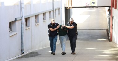 Officers escort a fugitive FETÖ suspect captured in an operation, in Adana, southern Türkiye, Nov. 10, 2023. (IHA File Photo)