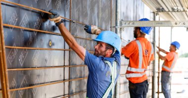 Construction staff work at a construction site in Munich, Germany, July 1, 2025. (Reuters Photo)