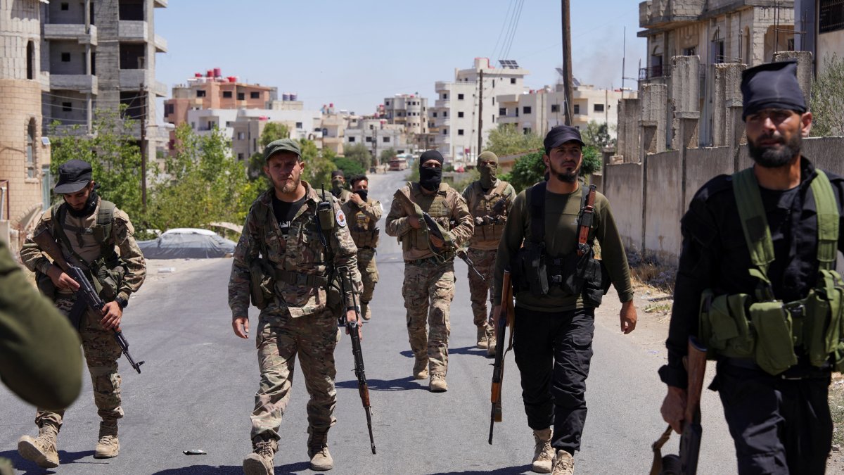 Syrian security forces walk together along a street, after clashes between Syrian government troops and local Druze fighters resumed, Suwayda, Syria, July 16, 2025. (Reuters Photo)