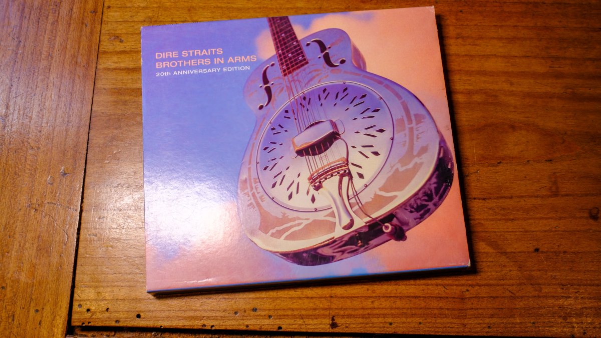 The front cover of the 20th Anniversary Edition of Dire Straits’ “Brothers in Arms” compact disc is seen on a table, New Orleans, U.S., April 28, 2023. (Shutterstock Photo)