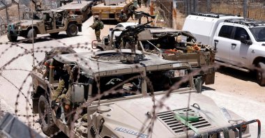 Israel military vehicles drive along the border fence into Israel, near the town of Majdal Shams, in the Israeli-occupied Golan Heights, Syria, July 17, 2025. (AFP Photo)