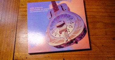 The front cover of the 20th Anniversary Edition of Dire Straits’ “Brothers in Arms” compact disc is seen on a table, New Orleans, U.S., April 28, 2023. (Shutterstock Photo)