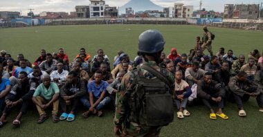 A M23 rebel stands guard at the the Unite stadium as members of the armed forces of the Democratic Republic of the Congo (FARDC) and Wazalendo troops wait to be taken aboard trucks for training by M23 rebels, in Goma, North Kivu, Democratic Republic of Congo, May 10, 2025. (Reuters Photo)