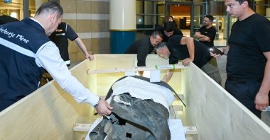 Turkish officials examine the bronze statue of Marcus Aurelius, looted from the ancient city of Boubon in the 1960s, during its return from the U.S., Ankara, Türkiye, July 19, 2025. (AA Photo) 