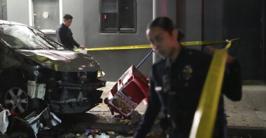Law enforcement investigate the scene where a vehicle rammed into a crowd of people waiting to enter a nightclub along a busy boulevard in Los Angeles, July 19, 2025. (AP Photo)
