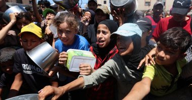 Palestinians gather to receive food from a charity kitchen, amid a hunger crisis, in Nuseirat, central Gaza Strip, Palestine, July 20, 2025. (Reuters Photo)
