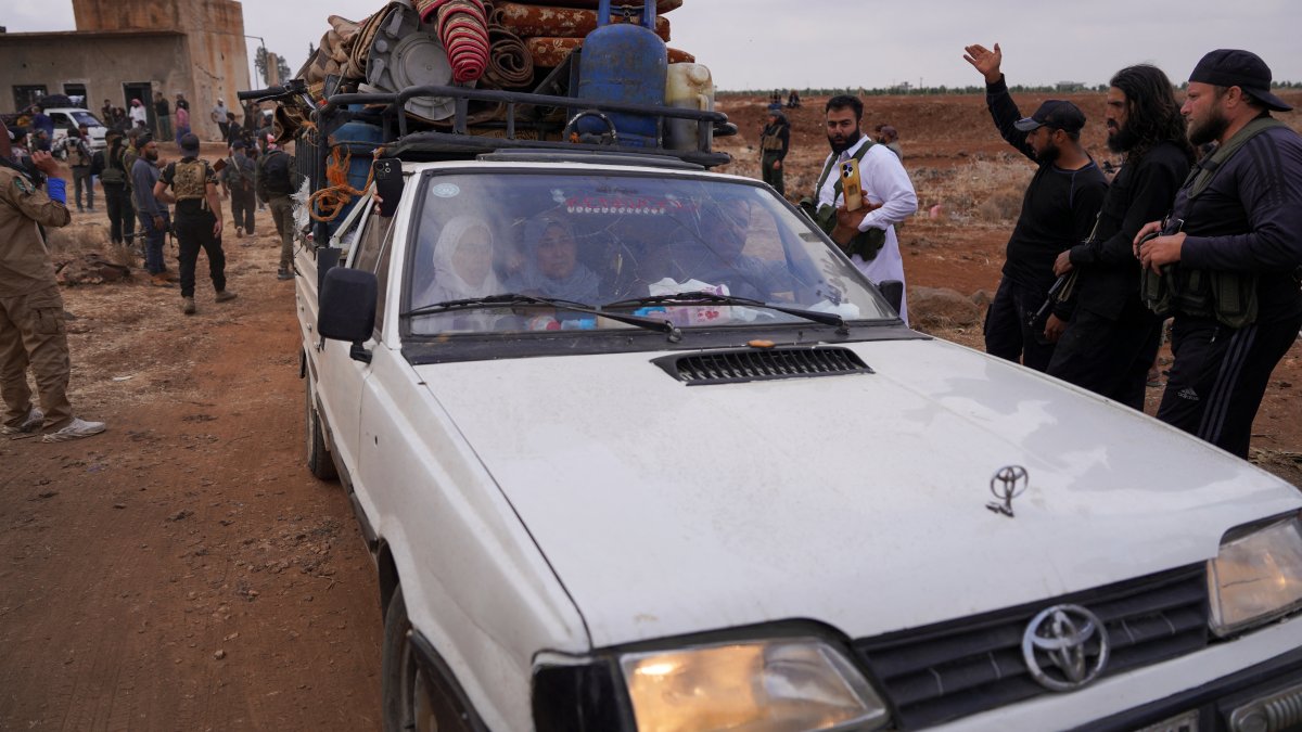 Bedouin family rides in a vehicle with belongings as they leave the village of al-Mazraa, in Suwayda, southern Syria, July 21, 2025. (Reuters Photo)