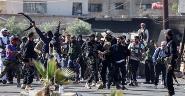 Druze militias escort a Druze prisoner while trying to prevent Bedouin fighters from advancing toward Sweida, Walgha, Suwayda province, Syria, July 19, 2025. (Reuters Photo)