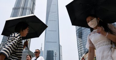 People walk near the Shanghai World Financial Center, where a Wells Fargo office is located, in the Lujiazui financial district of Shanghai, China, July 18, 2025. (Reuters Photo)