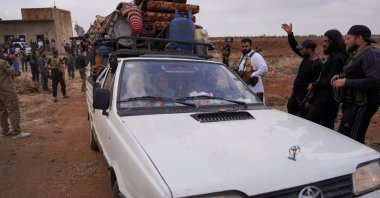 Bedouin family rides in a vehicle with belongings as they leave the village of al-Mazraa, in Suwayda, southern Syria, July 21, 2025. (Reuters Photo)