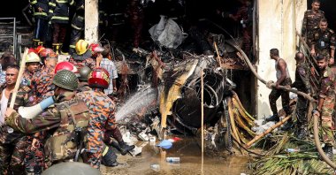 Bangladeshi emergency workers conduct a search and rescue operation after an air force training jet crashed into a school in Dhaka, Bangladesh, July 21, 2025. (AFP Photo)