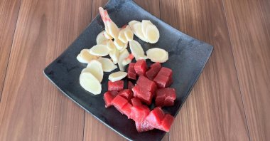 Bite size tuna chunks and sliced ginger, ingredients for a Japanese preserved food, called tsukudani, is displayed in the Tsukuda neighborhood, Tokyo, Japan, June 30, 2025. (AP Photo)