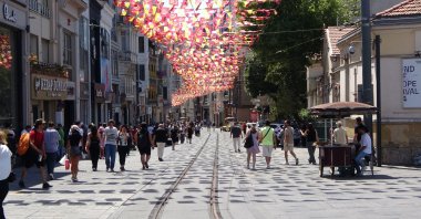 People walk along the Istiklal Avenue, one of the main shopping streets in Istanbul, Türkiye, July 17, 2025. (IHA Photo)