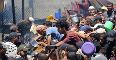 Palestinians gather at a food distribution point in the Nuseirat refugee camp in the central Gaza Strip, Palestine, July 19, 2025. (AFP Photo)