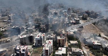 An aerial view shows smoke rising in the city of Suwayda, southern Syria, July 19, 2025. (AFP Photo)