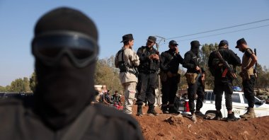Syrian government security forces stand atop an earth barrier they created as a buffer during their deployment in Busra al-Harir, southern Daraa province, Syria, July 21, 2025. (AFP Photo)