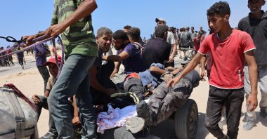 People transport men, wounded as he waited for humanitarian aid, along al-Rashid street in western Jabalia, Gaza, Palestine, June 22, 2025. (AFP Photo)