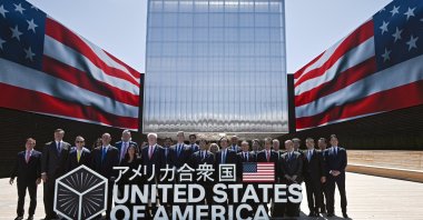 U.S. Treasury Secretary Scott Bessent (C-L) and Japan&#039;s Economic Revitalization Minister and chief trade negotiator Ryosei Akazawa (C-R) pose with a delegation in front of the USA Pavilion during a photo session after the USA National Day ceremony at the Osaka World Expo 2025, in Osaka, Japan, July 19, 2025. (EPA Photo)