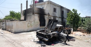 A damaged car and house are seen in the town of al-Mazra'a, Suwayda, southern Syria, July 18, 2025. (EPA Photo)