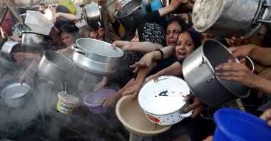 Palestinians wait to receive food in the al-Rimal neighborhood of Gaza City, central Gaza, Palestine, July 20, 2025. (DHA Photo)