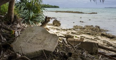 A gravestone lies just feet from the shoreline on Pele Island, Vanuatu, July 18, 2025. (AP Photo)