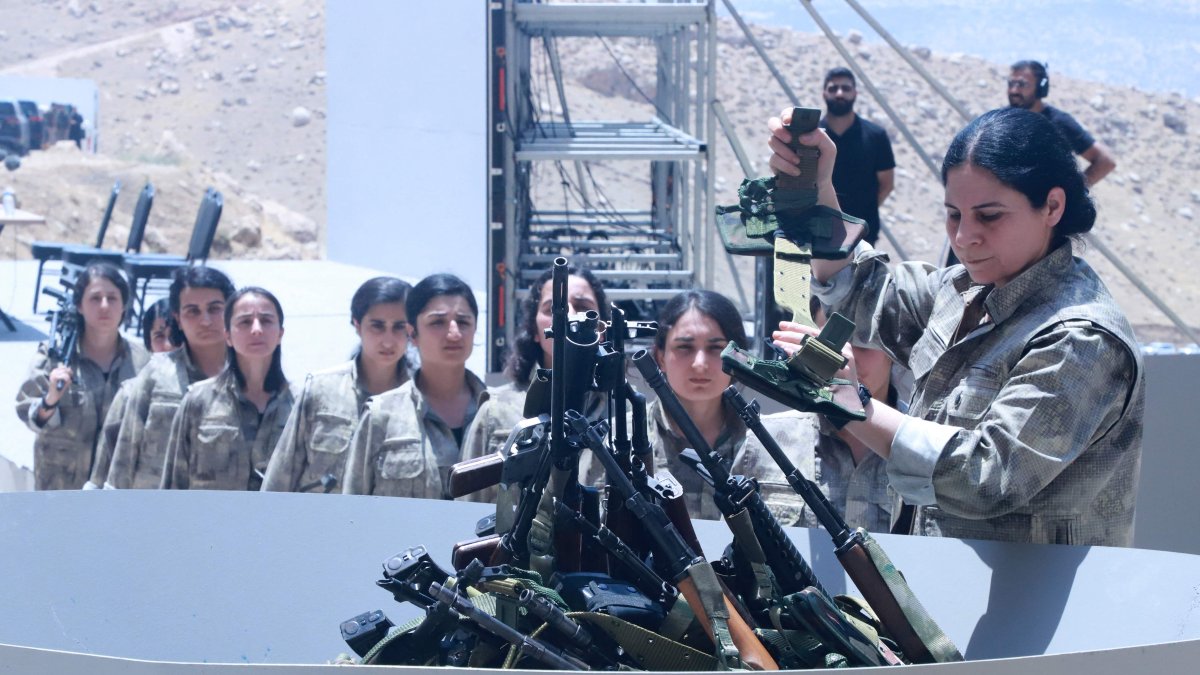 PKK terrorists line up to put their weapons into a pit during a disarmament ceremony, in the city of Sulaymaniyah, Iraq, July 11, 2025. (AFP Photo)