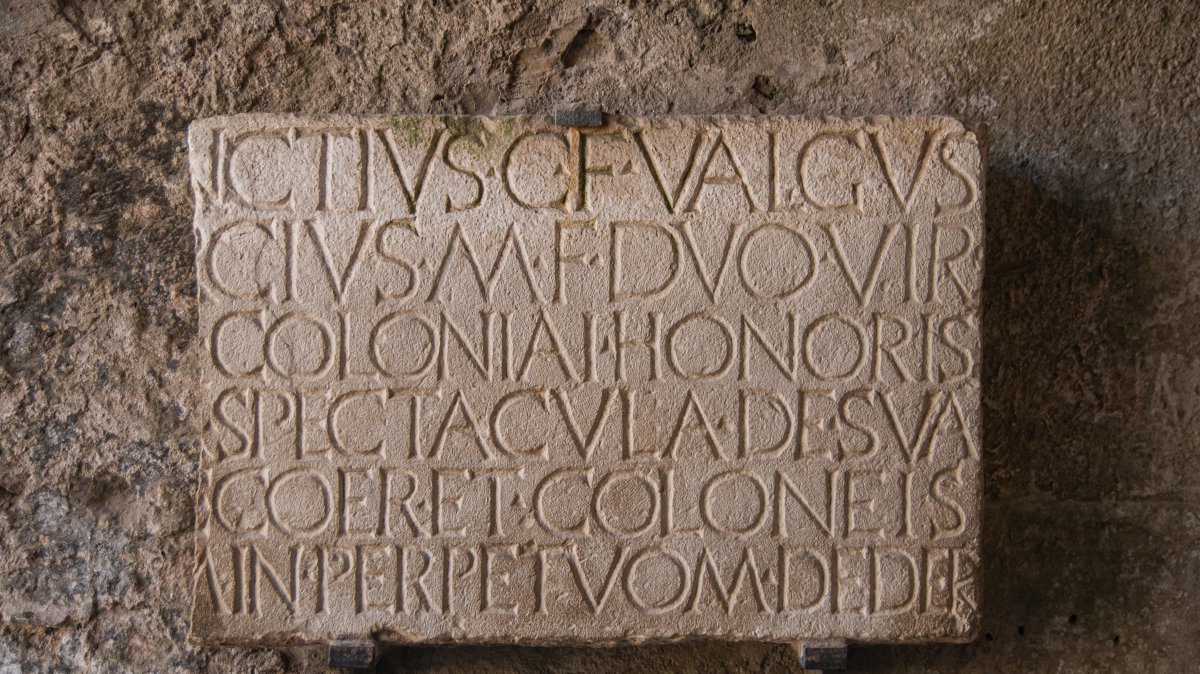 An ancient stone tablet with a carved inscription, Pompeii, Italy, July 3, 2022. (Shutterstock Photo)