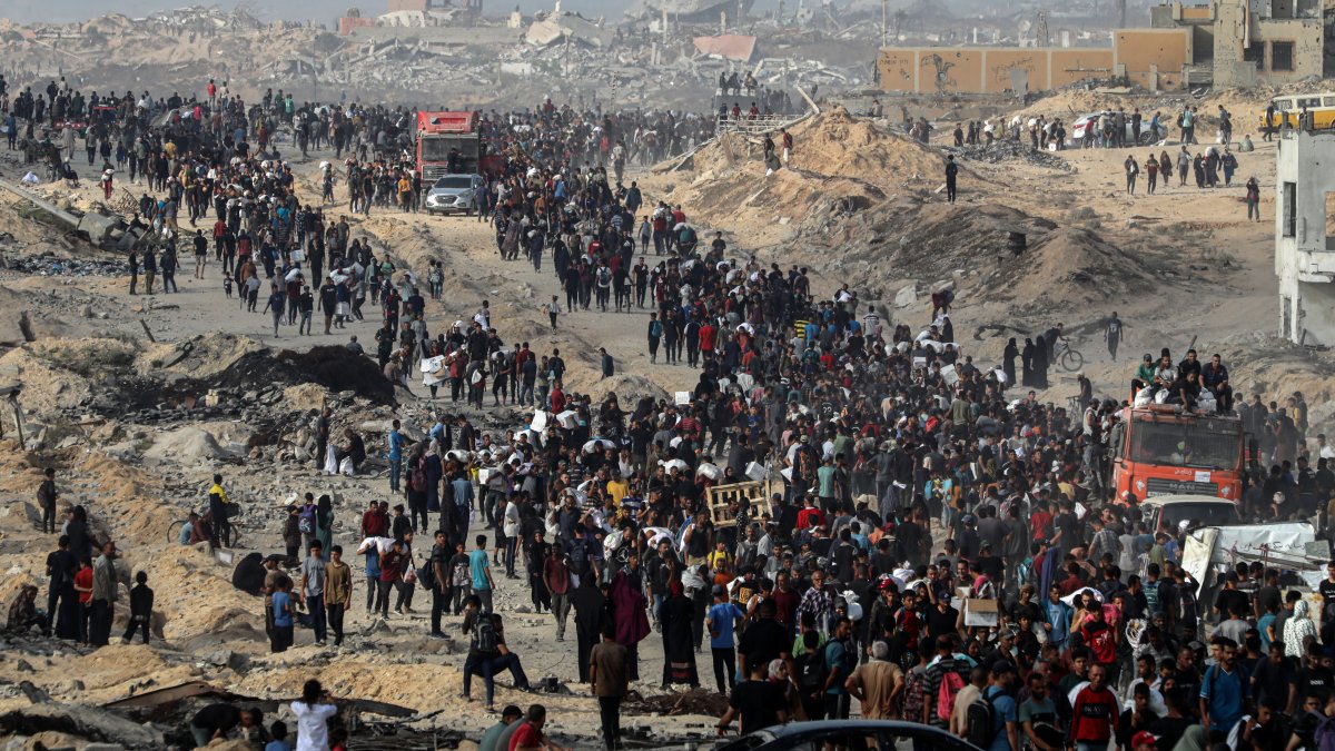Palestinians carry aid they received from trucks that entered the northern Gaza Strip, at a street north of Gaza City, June 22, 2025. (Xinhua via DHA)