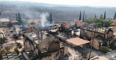 An aerial view shows burnt houses as firefighters battle a forest fire in the village of Souni, Limassol province, Greek Cypriot administration, July 24, 2025. (AFP Photo)