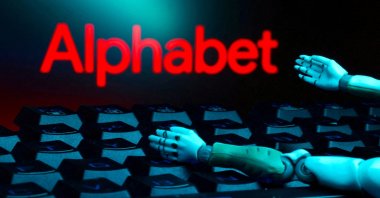 The Alphabet logo, a keyboard and robot hands are seen in this illustration created on Jan. 27, 2025. (Reuters Photo)
