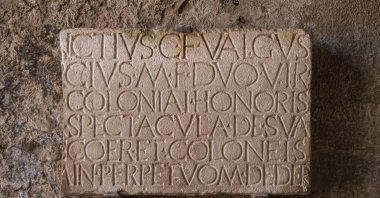An ancient stone tablet with a carved inscription, Pompeii, Italy, July 3, 2022. (Shutterstock Photo)