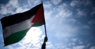 A protester holds a Palestinian flag during a rally called by several French organisations in support of the Palestinian people at Place de la Republique in Paris, France, May 7, 2024.