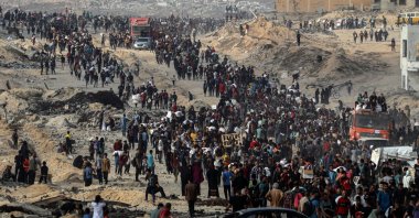 Palestinians carry aid they received from trucks that entered the northern Gaza Strip, at a street north of Gaza City, June 22, 2025. (Xinhua via DHA)