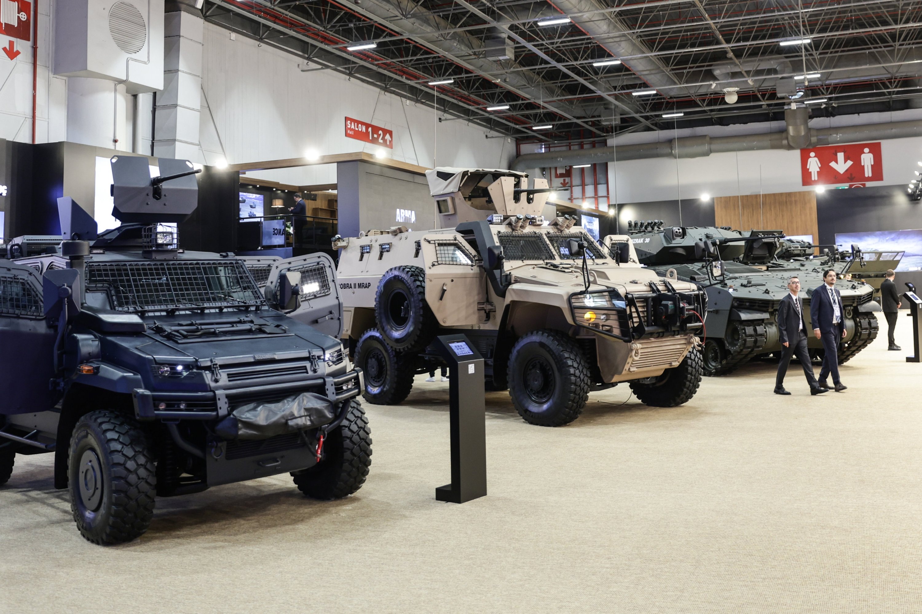 People pass by the Turkish Otokar's exhibition stand at the International Defence Industry Fair (IDEF) in Istanbul, Türkiye, July 22, 2025. (EPA Photo)