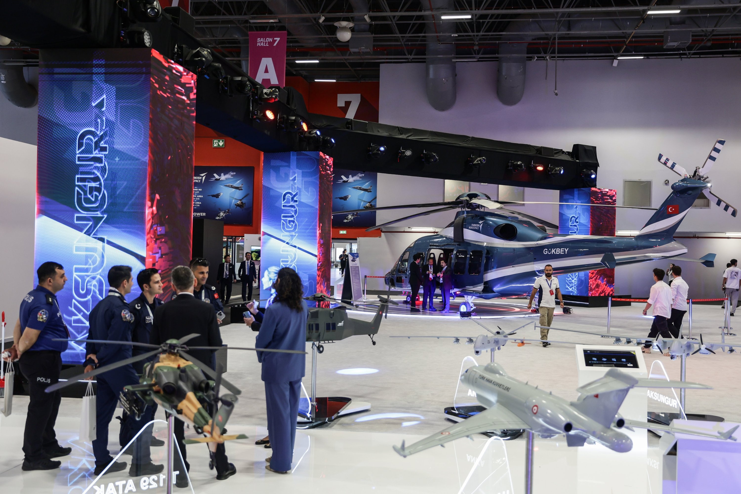 People stand in front of the T-625 Gökbey helicopter of the Turkish Aerospace Industries (TAI) during the International Defence Industry Fair (IDEF) in Istanbul, Türkiye, July 22, 2025. (EPA Photo)