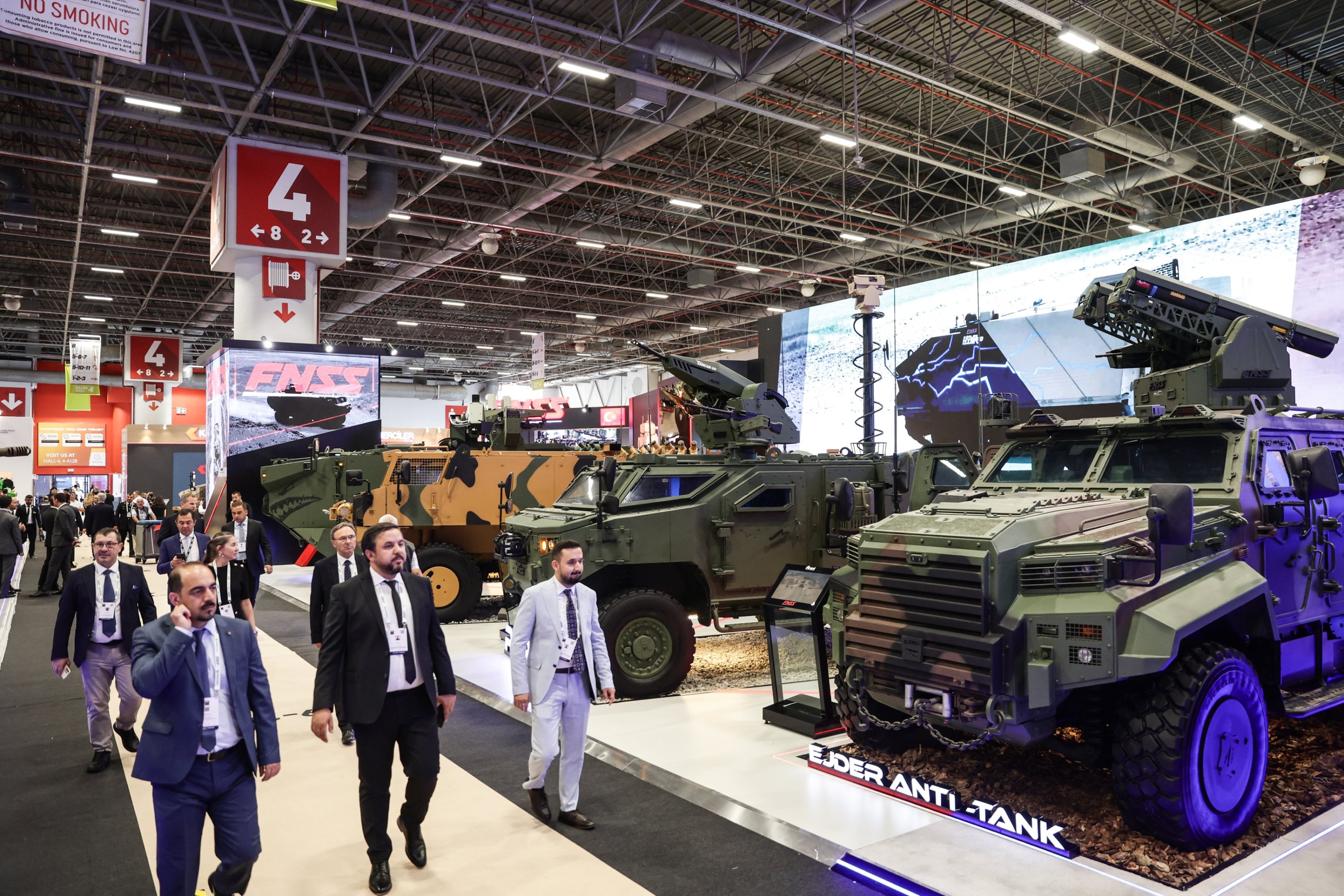 People walk in front of the Turkish FNSS exhibition stand at the International Defence Industry Fair (IDEF) in Istanbul, Türkiye, July 22, 2025. (EPA Photo)