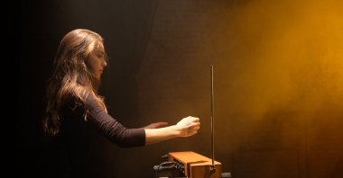 A girl plays a Theremin. (Shutterstock Photo)