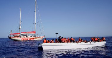 Migrants on a fiberglass boat wait to be assisted by NGO Open Arms rescue boat &amp;quot;Astral&amp;quot; in international waters south of Lampedusa, in the Mediterranean Sea, July 24, 2025. (Reuters Photo)