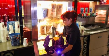 The record-breaking popcorn bucket is filled with popcorn at the TCL Chinese Theater, Hollywood, California, U.S., July 24, 2025. (AFP Photo)