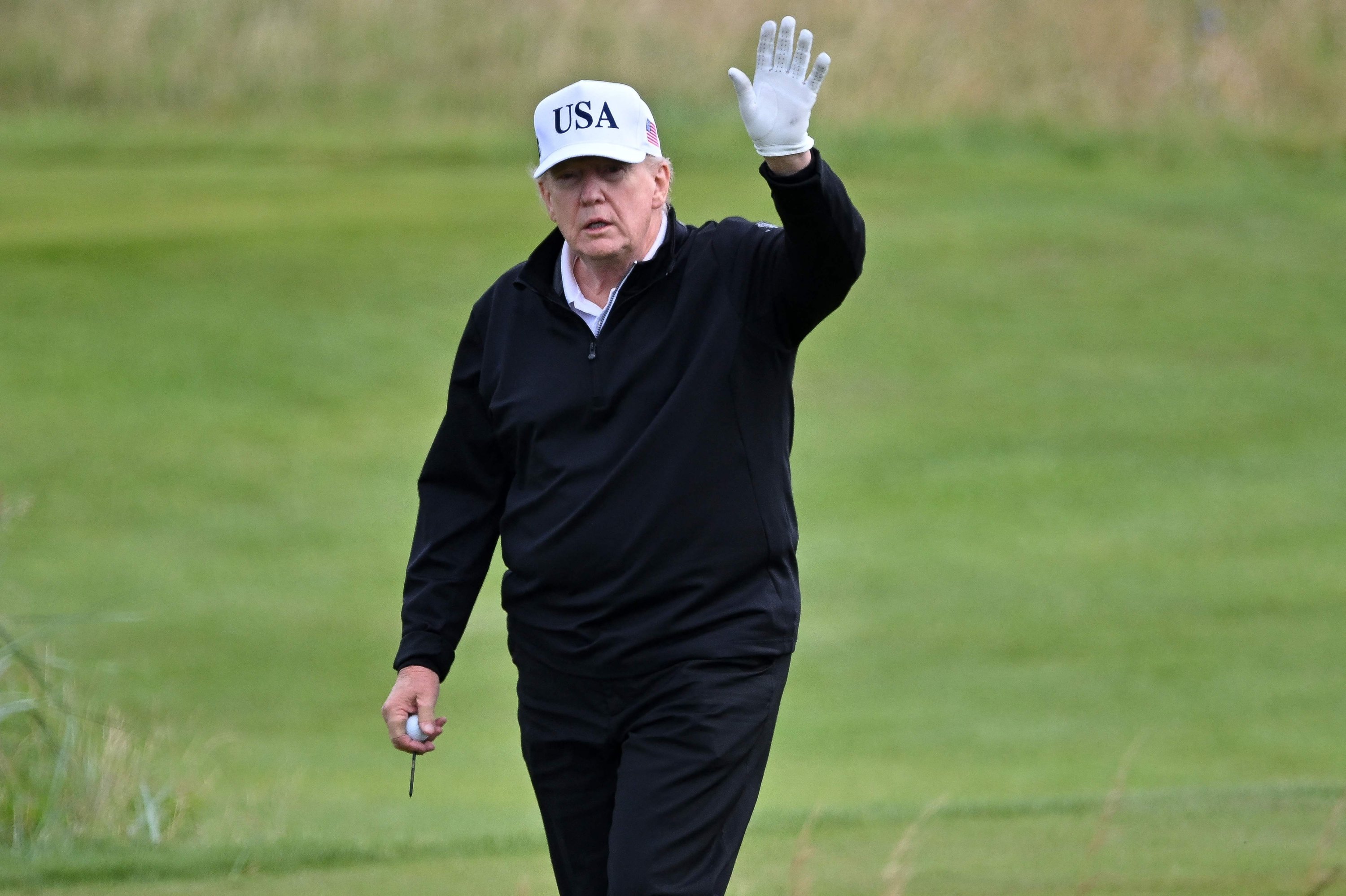 Trump seen golfing in Scottish course as protestors to rally