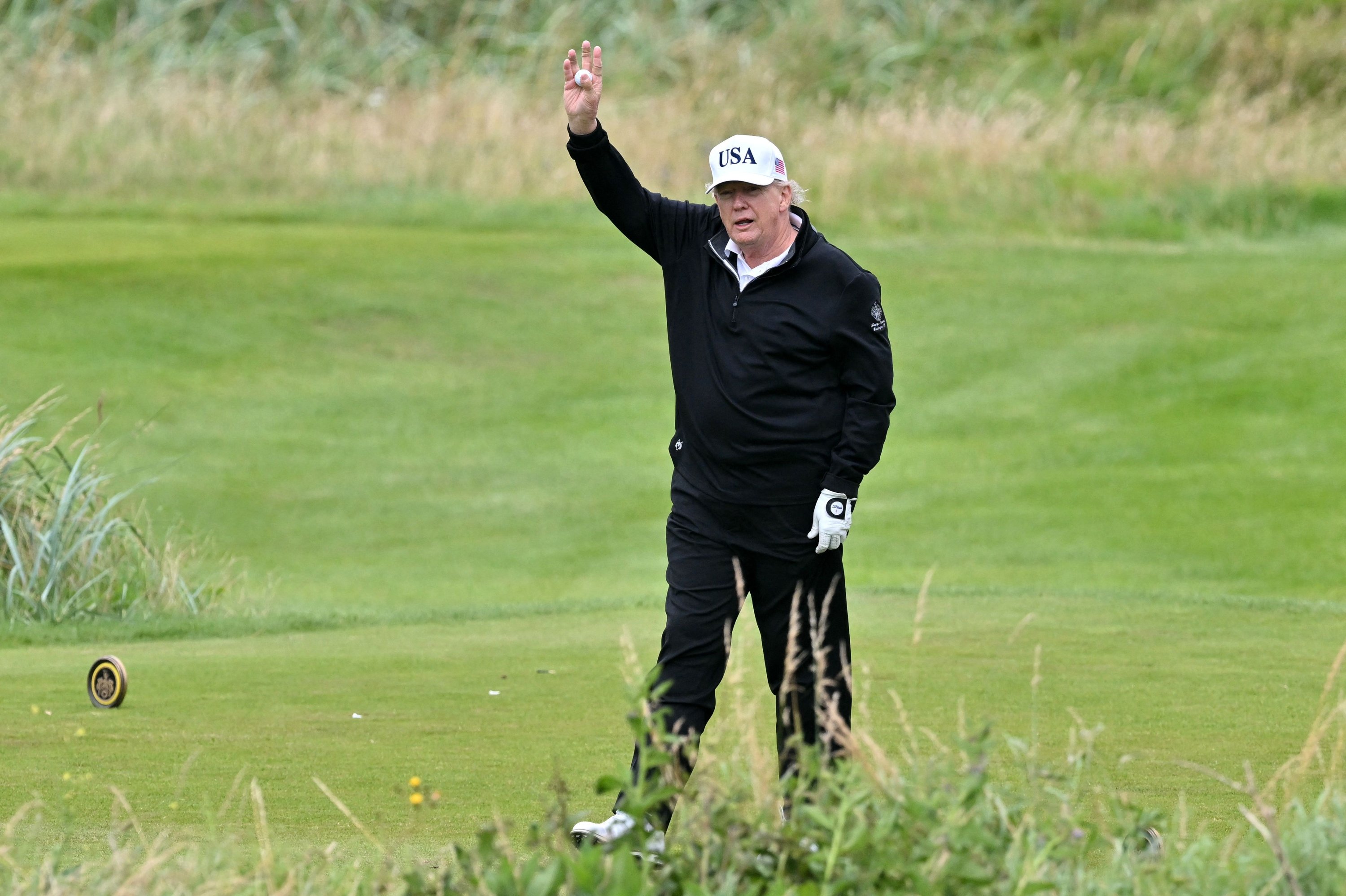 U.S. President Donald Trump reacts as he plays golf at the Trump Turnberry Golf Courses in Turnberry, Scotland, July 27, 2025. (AFP Photo)