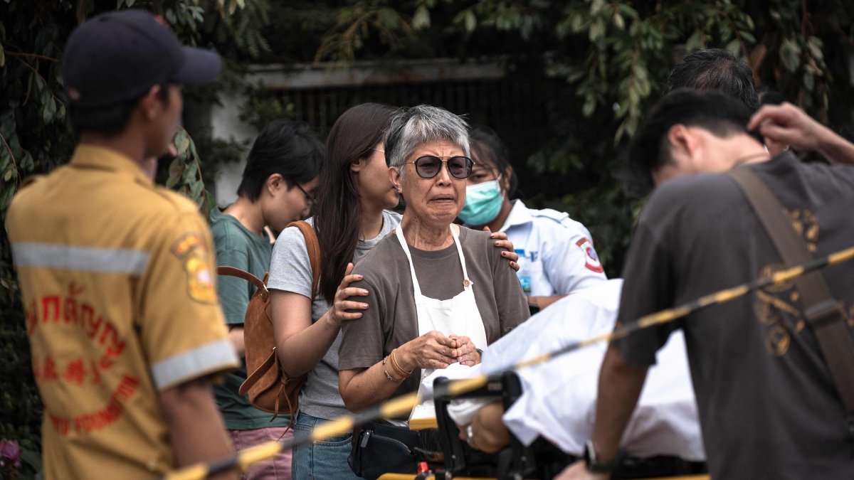 A woman reacts over the body of a shooting victim at Or Tor Kor market in Bangkok, Thailand, July 28, 2025. (AFP Photo)