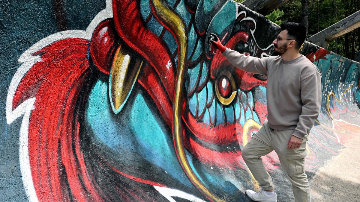 Bosnian street artist Kerim Musanovic puts the finishing touches on his painting on the former Olympic bobsleigh track on Mount Trebevic, near Sarajevo, Bosnia-Herzegovina, May 22, 2025. (AFP Photo)