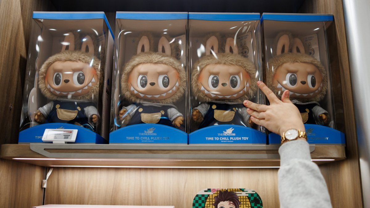 A customer reaches out for a box with a toy figure in the first Pop Mart store selling Labubu toys in Berlin, Germany, July 25, 2025. (EPA Photo)