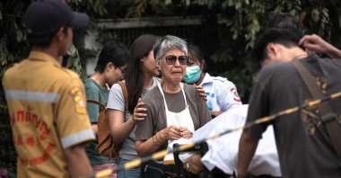 A woman reacts over the body of a shooting victim at Or Tor Kor market in Bangkok, Thailand, July 28, 2025. (AFP Photo)