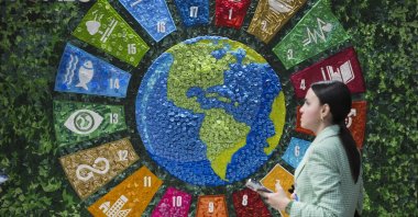 A person walks past art in the Türkiye Pavilion at the COP29 U.N. Climate Summit in Baku, Azerbaijan, Nov. 14, 2024. (AP Photo)