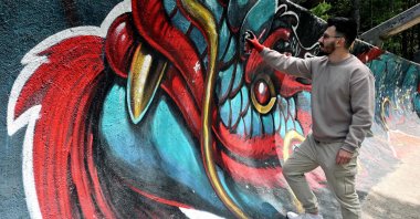 Bosnian street artist Kerim Musanovic puts the finishing touches on his painting on the former Olympic bobsleigh track on Mount Trebevic, near Sarajevo, Bosnia-Herzegovina, May 22, 2025. (AFP Photo)