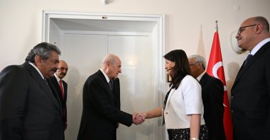 MHP leader Devlet Bahçeli (L) shakes hands with DEM Party MP Pervin Buldan during a meeting on a terror-free Türkiye, Ankara, Türkiye, July 16, 2025. (AA Photo)