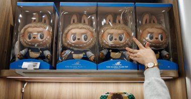 A customer reaches out for a box with a toy figure in the first Pop Mart store selling Labubu toys in Berlin, Germany, July 25, 2025. (EPA Photo)